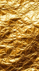 Obraz premium Highly detailed texture features crinkled metallic material with a rich golden hue.