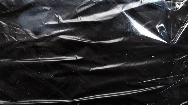 Abstract black plastic texture background with glossy and shiny surface and reflections