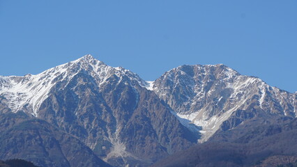 Fototapeta premium Fall Colors Beneath Snow-Capped Mountains, Hakuba, Nagano, Japan