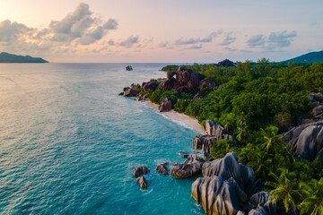 Fototapeta premium Discover the stunning beauty of Anse Source d'Argent beach in La Digue, Seychelles at sunset