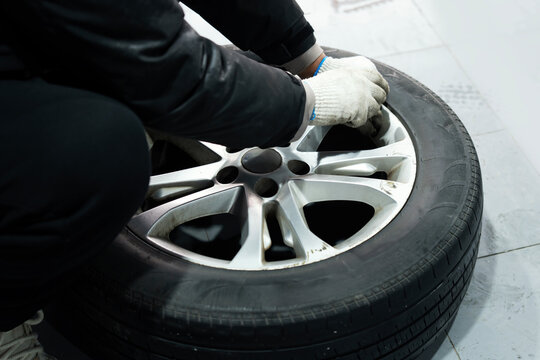 Person Working on Vehicle Tire and Wheel Repair