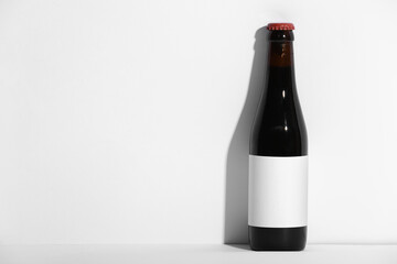 Bottle of cold beer on grey background