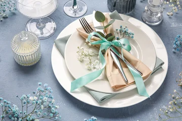 Fototapete Rund Zu Essen Beautiful table setting for wedding with gypsophila flowers and candle on blue background, closeup  © Pixel-Shot