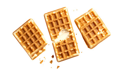 Overhead shot of four crispy, golden waffles, one with a bite taken out, on black