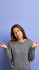 Confused Young Woman Shrugging Shoulders On Purple Background