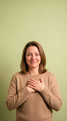 Grateful Woman Smiling With Tear On Cheek And Hands Over Heart