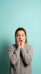 Surprised Woman With Hands On Face Against Blue Background