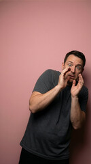 Frightened Man With Scared Expression Against Pink Background
