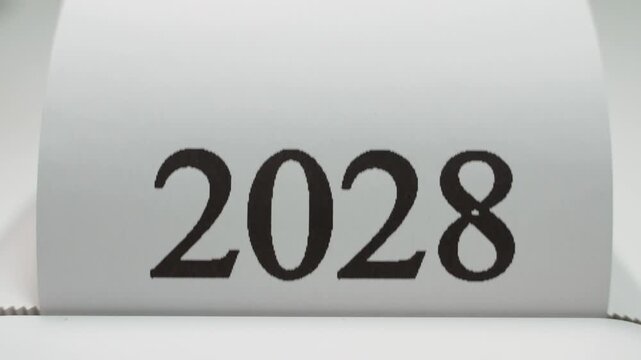 The number 2028 appears close-up on white paper