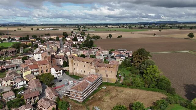 Aerial view of Calendasco village with fortified castle and church in Piacenza, Italy