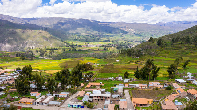 Aerial panoramic view of Colca Valley from Coporaque featuring ancient terraces and Andean mountains, Arequipa, Peru