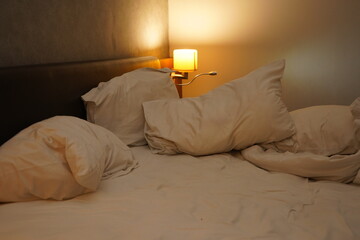 Pillows on hotel bad with warm light