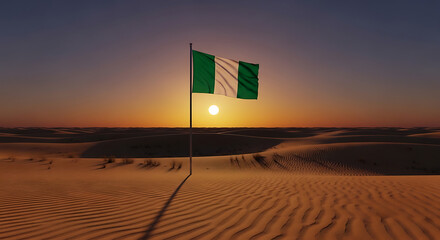 Green flag waving in the desert sand at sunset.