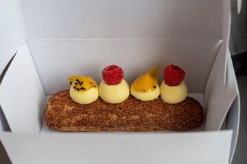 Raspberry and Passion Fruit &Eacute;clair in a carton box to Go