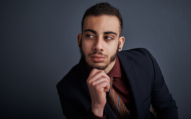 Fototapeta premium Businessman, thinking and decision in studio for career, realtor or mockup space on dark background. Person, broker and mindset for choice with property investing, suit and insight for real estate