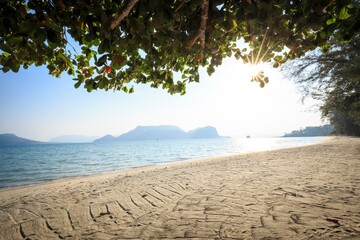 Golden Sunburst over Pristine Tropical Beach and Distant Islands