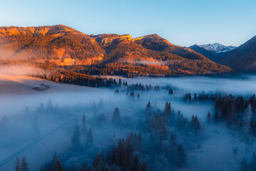 Aerial view of Liptov region at sunrise with High Tatras mountains in the background, Slovakia