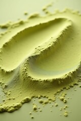 Obraz premium Close-up of vibrant green matcha powder artfully arranged on a neutral background showcasing its fine texture and rich color.