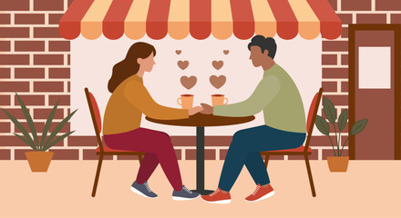 Young man and woman sitting outside cafe on a date. Valentine's Day concept