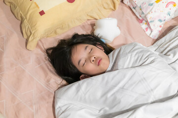 Obraz premium Young Asian Girl Sound Asleep in Bed