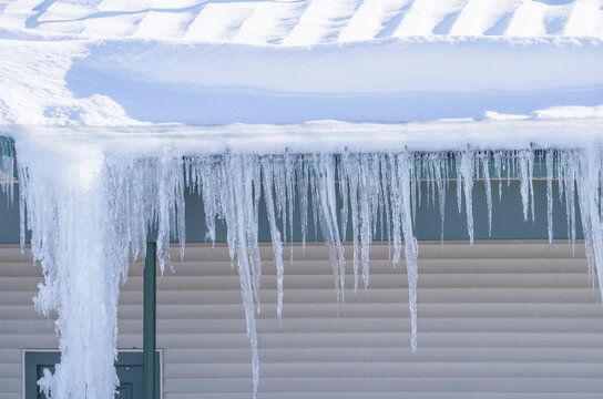 winter house with icicle and snow on the roof