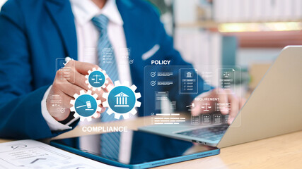 Businessman managing compliance and regulatory policy with digital legal icons, checklist, and...
