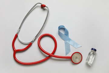 Naklejka premium Awareness ribbon with insulin and stethoscope on light background. Diabetes concept