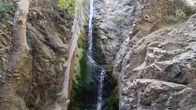 Dramatic waterfall in narrow Cyprus rocky gorge
