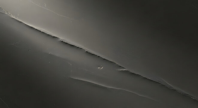 Close view of dark textured stone with visible lines and scratches providing a sense of depth and dimension