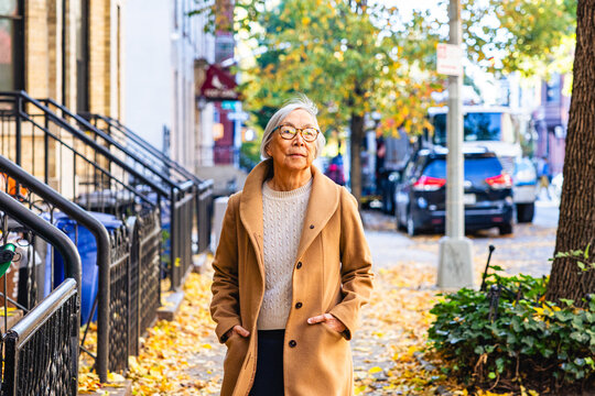 Senior Asian Woman walking on City Street