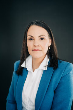 Mature woman wearing business attire making eye contact