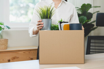unemployed concept, employee clear her stuff at office to move out after get layoff from company in...