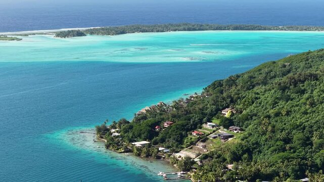 Bora Bora, French Polynesia. Drone Shot of Coastal Village, Turquoise Lagoon and Motu Islands on Coral Reef Barrier