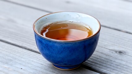 BlueCeramicTeaCupOnWoodenSurface