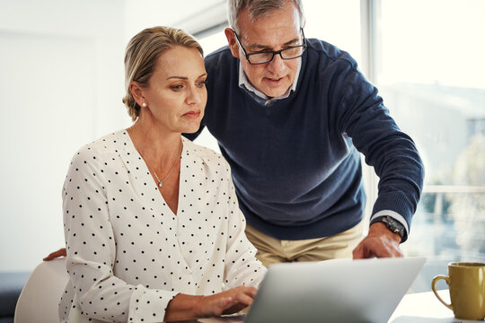Conversation, laptop and planning with couple in home together for budget or financial review. Computer, finance or wealth management with man and woman in apartment for insurance or tax discussion