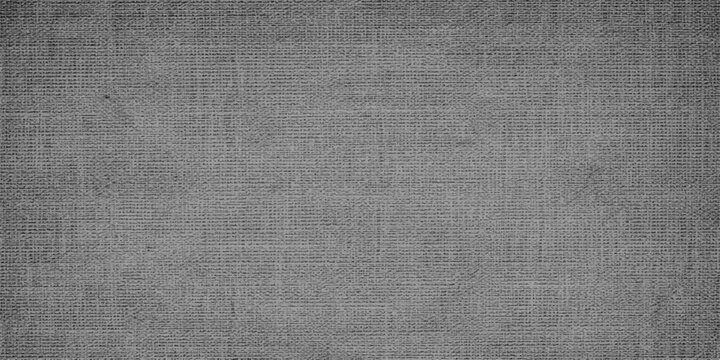 A vintage rough black and gray canvas textile material featuring a natural woven linen surface and grunge fiber pattern ideal for a blank textured cloth backdrop