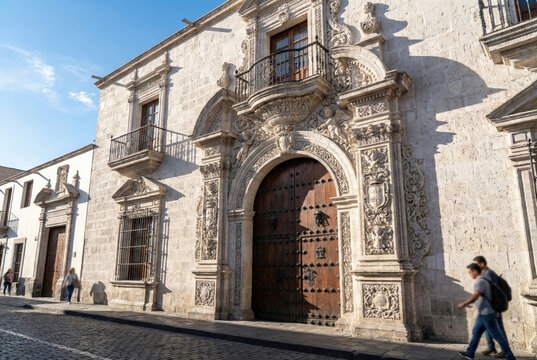 Ornate stone portal of Casa del Moral in Arequipa Peru with mestizo baroque carvings and colonial architecture
