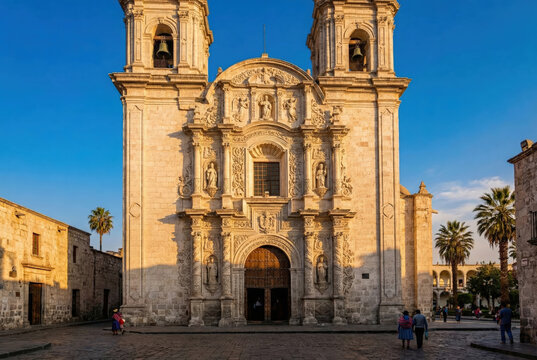 Facade of the Church of La Compa&ntilde;&iacute;a de Jes&uacute;s in Arequipa Peru with ornate mestizo baroque architecture at sunset
