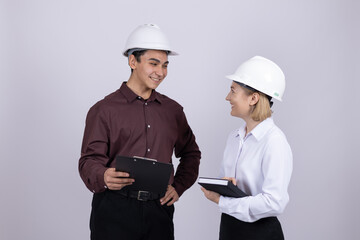 Male and female engineers discussing plan with tablet