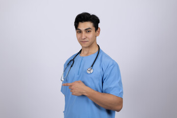 Professional male doctor in blue medical scrubs posing