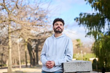 Young man posing in a casual urban park