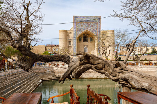 Lyabi-Hauz ensemble in Bukhara, Uzbekistan, with historic pond and Kukeldash Madrasa, traditional Islamic architecture and city life