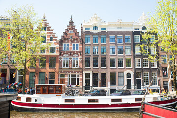 Facades of old historic Houses and trees over canal water, Amsterdam, Netherlands. High quality photo
