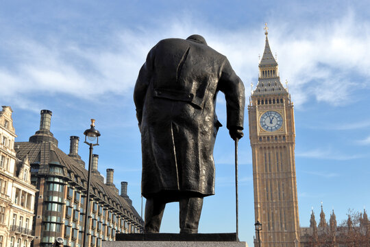 The bronze statue of Winston Churchill, with Big Ben and Elizabeth Tower in the background, Parliament Square, London, UK