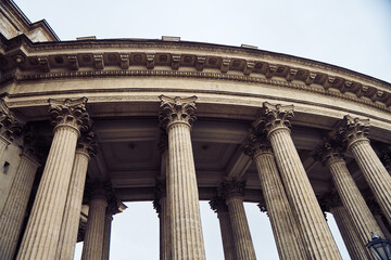 Naklejka premium Classic corinthian colonnade viewed from below against overcast sky