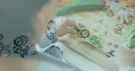 Cutting senior Indian in light sleeves slicing cucumber on kitchen cutting board with knife network © vectorfusionart