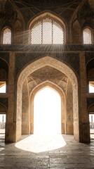 Obraz premium Tall mosque arch with Islamic patterns and soft sunlight