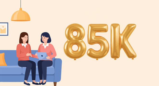 Two women share a tablet on a sofa with large gold 85K balloons