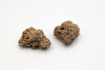 Natural volcanic lava stones from Tenerife, Canary Islands. Porous rock texture isolated on white background. Geology, volcanology, science and natural material concept.