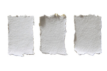 Obraz premium Three rectangular, deckled-edge white paper scraps against a stark black background